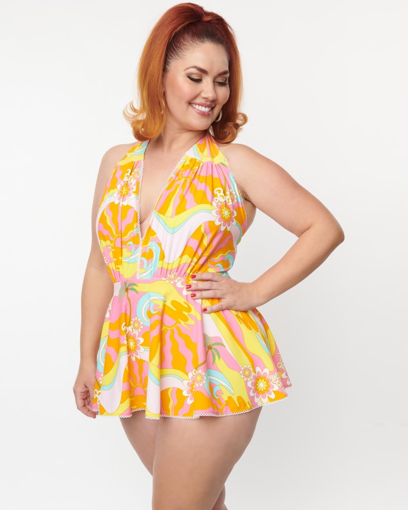 Front of a model wearing a size 1X Barbie x Unique Vintage Tropical Sunset Skirted Wendy Swimsuit in Orange, Yellow, Pink, Floral by Unique Vintage. | dia_product_style_image_id:287947